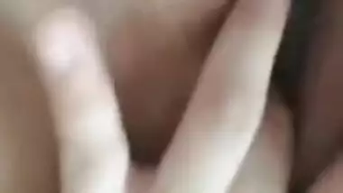 Naked Indian holds camera with one hand and fingers XXX hole with another