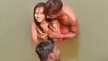 Village girl nude in river, naked boobs pressed by friends